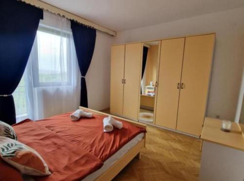 a bedroom with a bed with two towels on it at Apartment Sea View in Karlobag