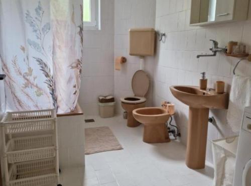 a bathroom with a toilet and a sink at Apartment Sea View in Karlobag