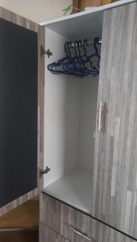 a cupboard with a mirror and a tv in it at Cuarto por candelaria 2026 in Puno
