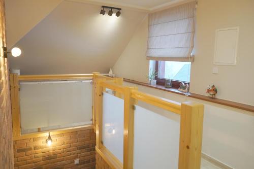 an attic room with a window and a brick wall at Pensjonat Halny Jaworzynka in Jaworzynka
