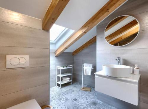 a bathroom with a sink and a mirror at Apartments Zanet & Niccolo in Fažana