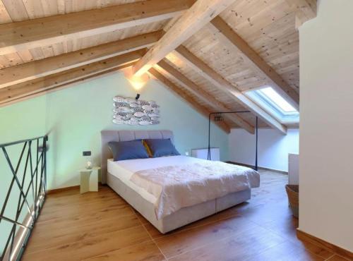 a bedroom with a large bed and wooden ceilings at Apartments Zanet & Niccolo in Fažana