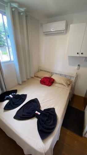 a bed with two robes on top of it at Solar do Braz Tiny House in Florianópolis