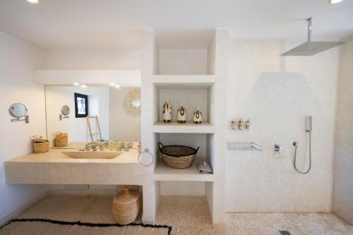 a white bathroom with a sink and a shower at Domaine Darsyada Boutique Hôtel Deluxe Et Spa in Marrakesh