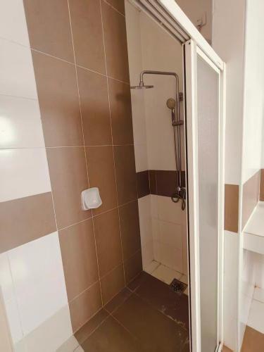 a bathroom with a shower with a glass door at Setia Alam Urban Rooms in Shah Alam