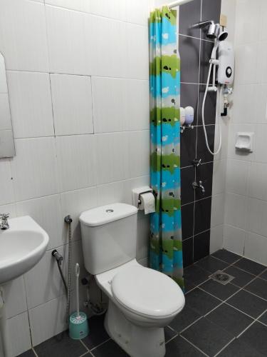 a bathroom with a toilet and a sink and a shower at IJM Condostay, Sandakan in Sandakan