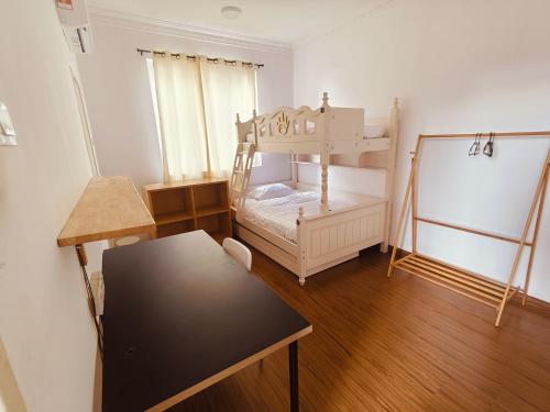 a small room with a bunk bed and a table at Setia Alam Urban Rooms in Shah Alam
