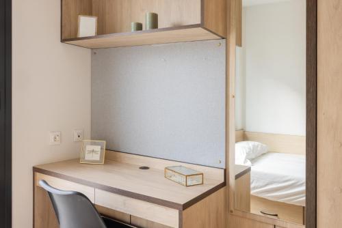 a bedroom with a desk with a mirror and a bed at Stephouse Pozuelo Europa in Madrid