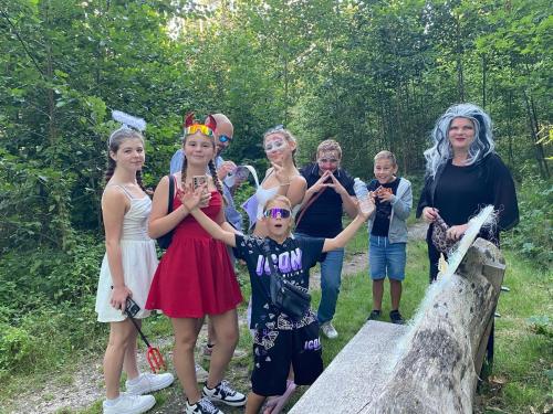 a group of people dressed in costumes standing on a bridge at Camping San Lanaco in Lanaken