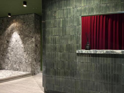 a room with a red curtain and a red curtain at AV Hotel Milano in Milan