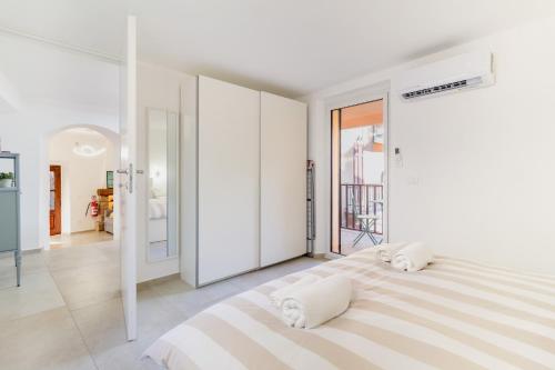 a white bedroom with a large bed with two pillows at La Casa sulla Cascata in Colonno