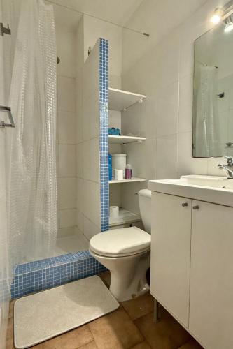 a bathroom with a toilet and a shower and a sink at Studio cabine première ligne in Fleury