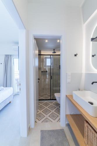 a bathroom with a sink and a shower at Elia serenity apartment 4 in Mesochórion