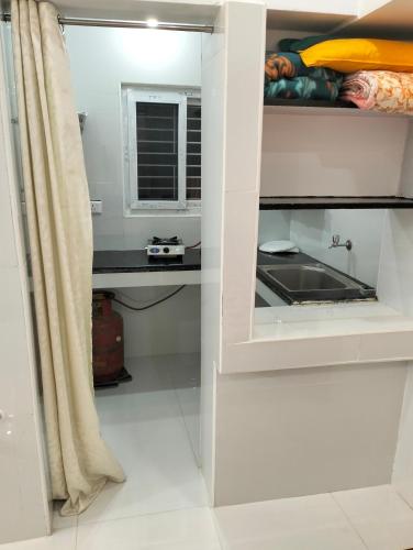 a kitchen with a sink and a counter at CRUZ Palace in Jāmb