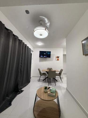 a living room with a table and a dining room at Moon Apartamento C2 in San Cristóbal