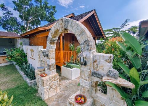 a stone fireplace in front of a house at The Kori Sire in Tanjung
