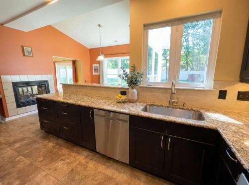a kitchen with a sink and a fireplace at Charming Ranch Retreat in Bear Delaware in Bear