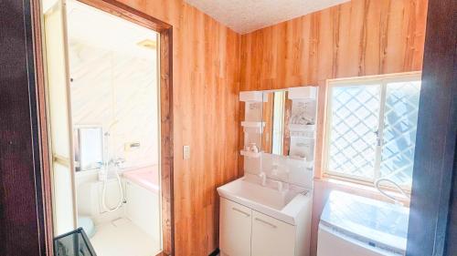 a bathroom with a sink and a toilet and a window at SORA Blue House, 海辺の隠れ家, ペットBBQ可, 全3寝室&リビングオーシャンビュー,一棟貸切 in Hokota