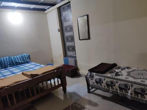 a bedroom with two beds in a room at Danny's Homestay Coorg in Madikeri