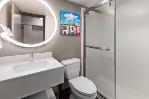 a bathroom with a toilet and a sink and a mirror at Holiday Inn Express & Suites Washington DC - NoMA by IHG in Washington, D.C.