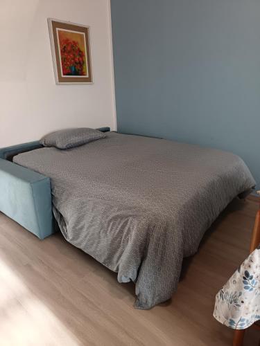 a bedroom with a bed with a blanket on it at La Casa di Abe - Cuneo in Cuneo