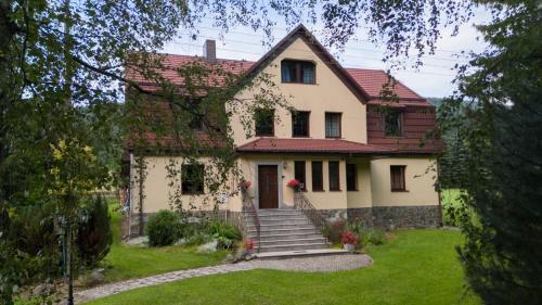 a large white house with a red roof at Góry Sowie Agroturystyka in Rzeczka