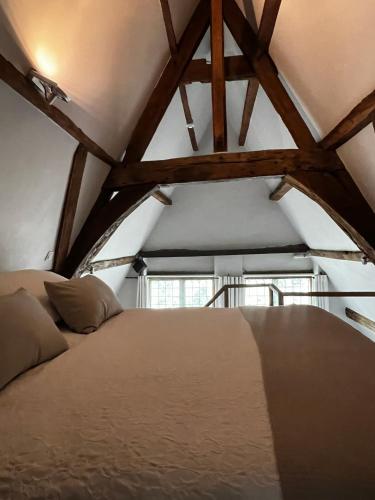 a bedroom with a large bed in a attic at De Waterzooi Suites in Ghent