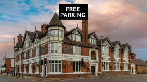 a large building with a free parking sign on it at Best Western The Plough Hotel in Northampton