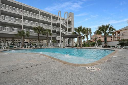 a large swimming pool in front of a building at Tipsea on the seawall in Galveston