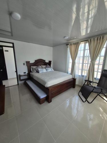 a bedroom with a bed and a television in it at Hotel Casa Bambu in Calima