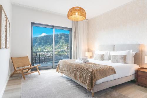 a bedroom with a large bed and a large window at Villa Sofia by Atlantic Holiday in Machico