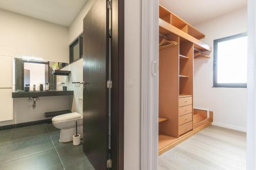 a bathroom with a toilet and a sink at Villa Sofia by Atlantic Holiday in Machico