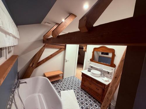 a bathroom with a sink and a mirror at A l'Ancienne Ferme in Steinseltz