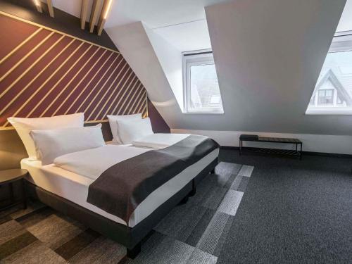 a bedroom with a large bed in a room at B&B Hotel Leipzig-City in Leipzig
