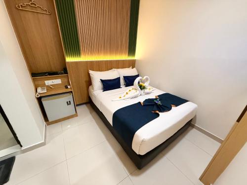 a hotel room with a bed with two swans on it at City Central Hotel in Kuala Lumpur