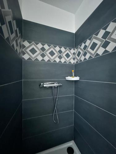 een badkamer met een douche met blauwe tegels bij Studio cosy in Frontignan
