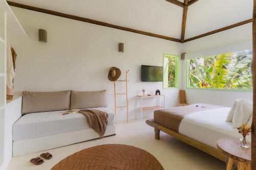 a bedroom with two beds and a window at Beco das Flores in Mata de Sao Joao
