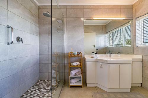 a bathroom with a sink and a shower at Majorca House in Somerset West