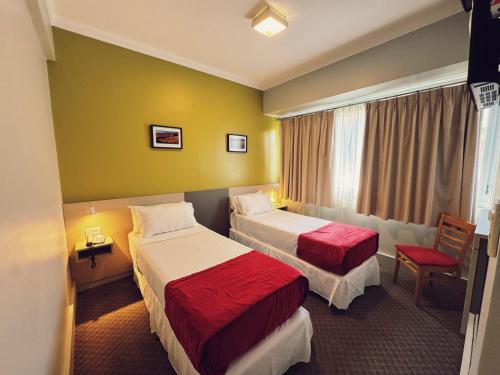 a hotel room with two beds and a window at Estepa Hotel in General Roca