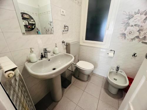 a white bathroom with a sink and a toilet at Suite Semeria 38 - Sanremo in Sanremo
