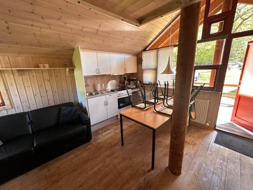 a living room with a couch and a table at noordwind camping galsklint in Middelfart