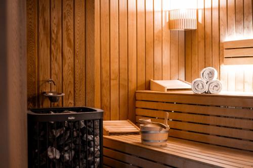 a room with a sauna with a tub and a stove at Araucaria Hotel & Spa in La Plagne
