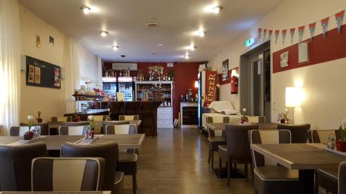 a restaurant with tables and chairs and a bar at Hotel Bergschlösschen in Boppard