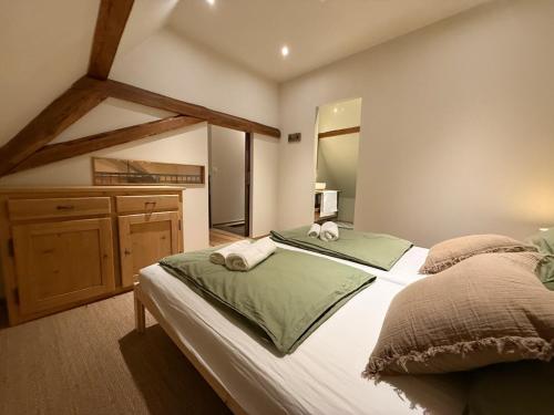a bedroom with a large bed and a dresser at A l'Ancienne Ferme in Steinseltz