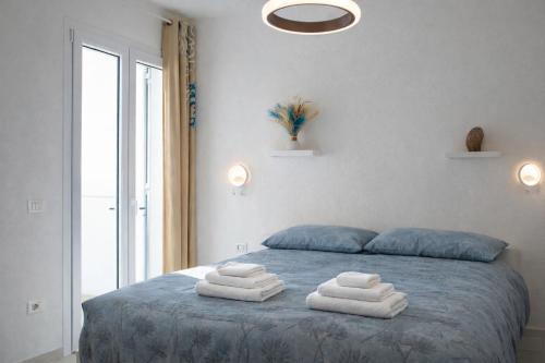 a bedroom with a bed with towels on it at Residenza Sa Olia in Budoni