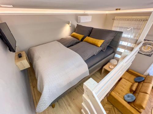 a small bedroom with a couch in a tiny house at Frida Loft in Pécs
