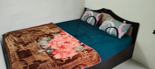 a bed with flowers and pillows on it at Mamta Home Stay in Ayodhya