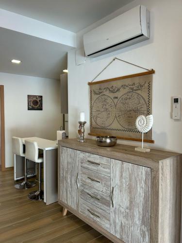 a kitchen with a large wooden cabinet with a table at Edificio Type I in Puente Genil