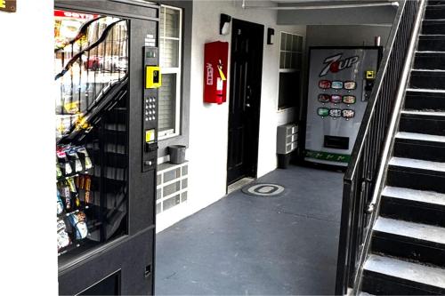 a vending machine in a building with a stair case at Woodbridge Inn By OYO Rome in Rome