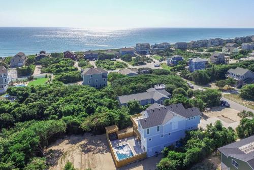an aerial view of a house and the ocean at Sea Fever - Duck, Saltaire, 130 Yds to Beach, Ocean View, Pool, Hot Tub, Tiki Bar, Flex Stays in Duck
